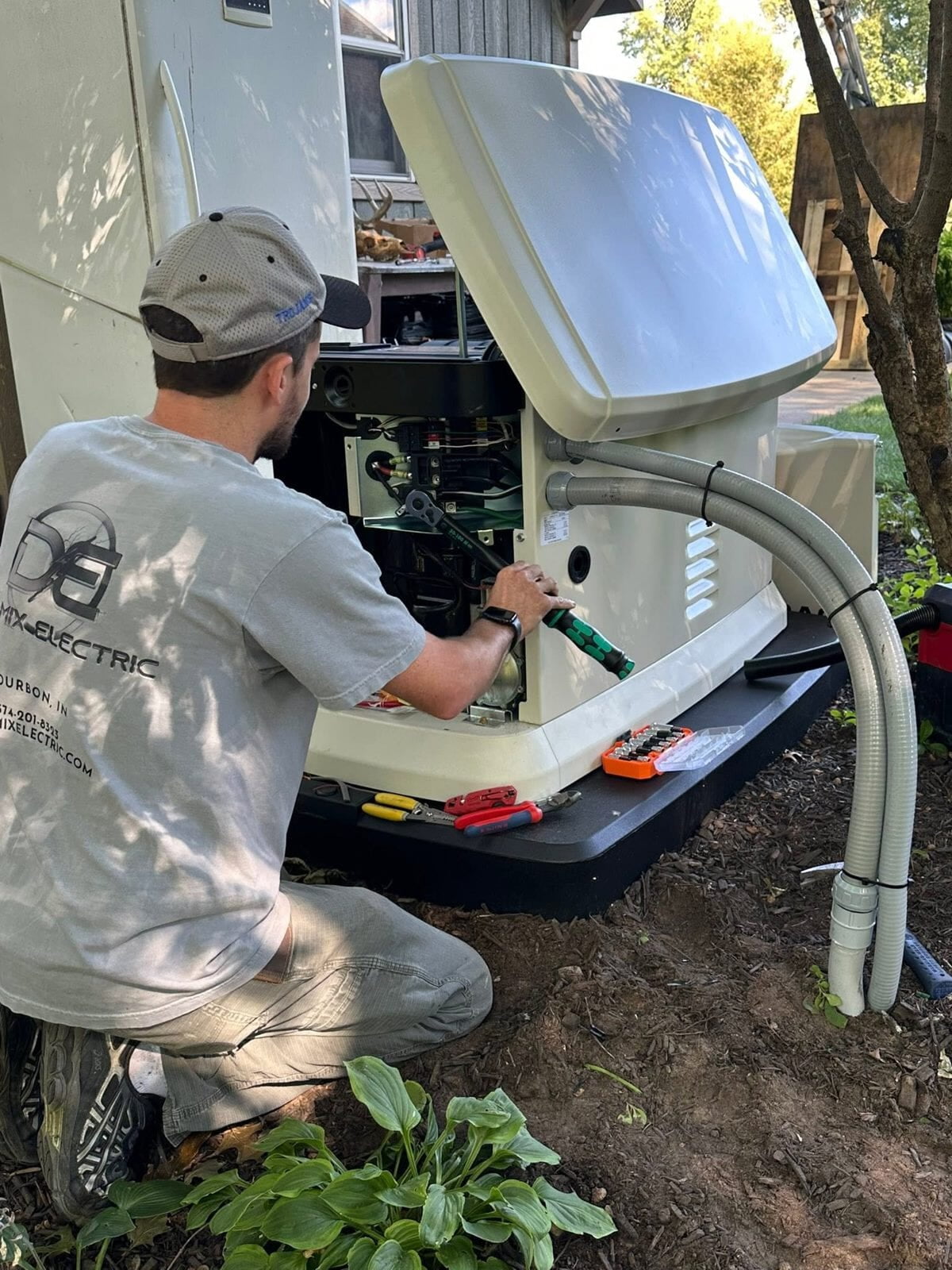 Dynamix Electric technician servicing a standby generator in Bourbon area